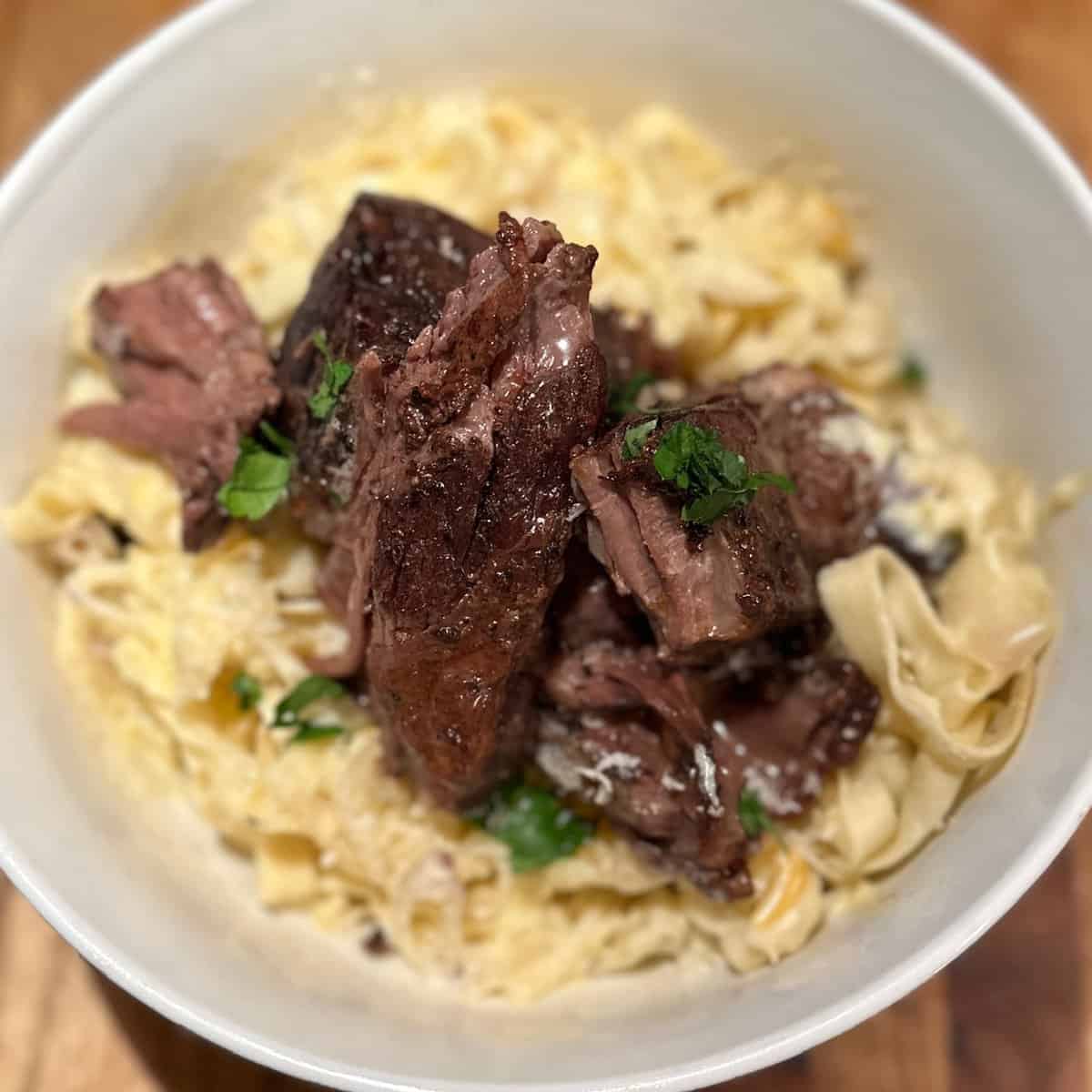 Short Rib fettuccine in a white bowl.