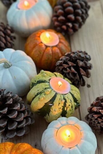 Pumpkin candles on a fall tablescape.