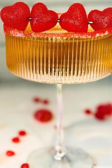 Fireball drink in a cocktail glass with a cinnamon gummy heart garnish.