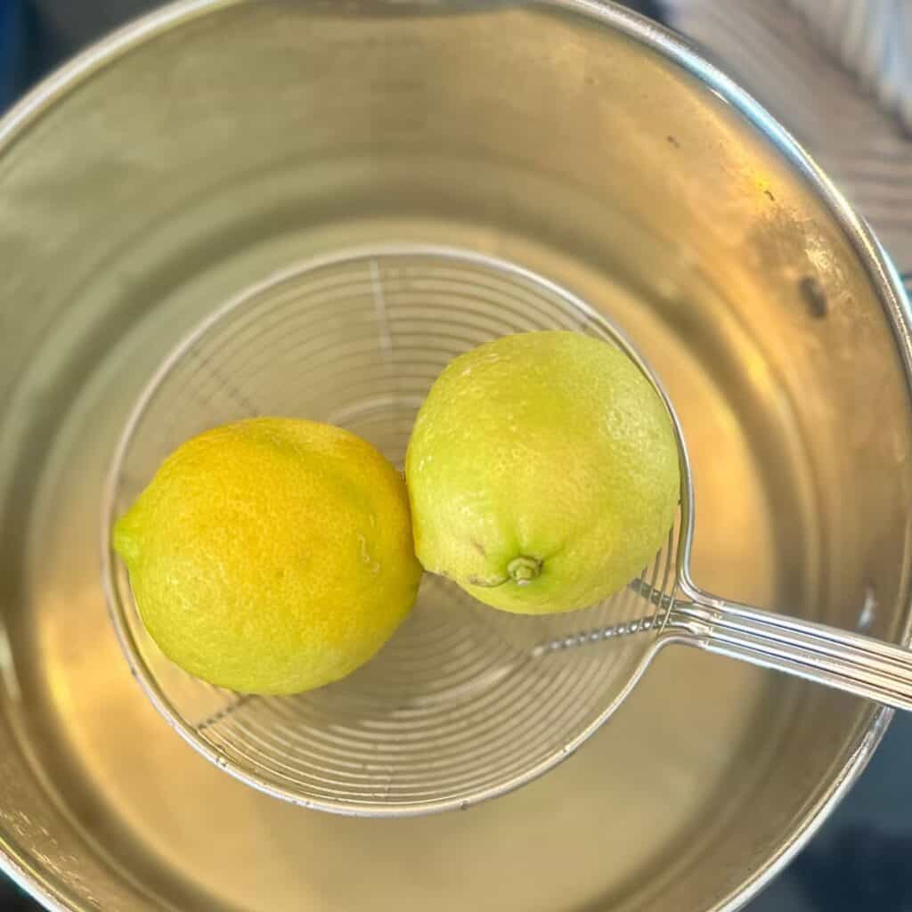Lemons being pulled from boiling water.