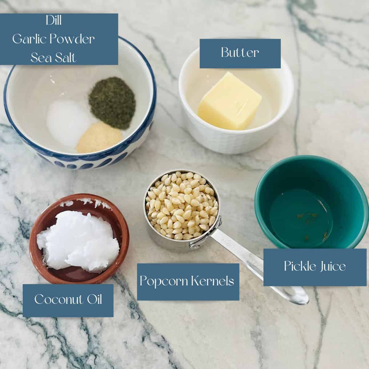 Ingredients for making pickle popcorn sitting on a white counter. 