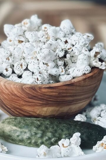Wooden bowl full of dill pickle popcorn.