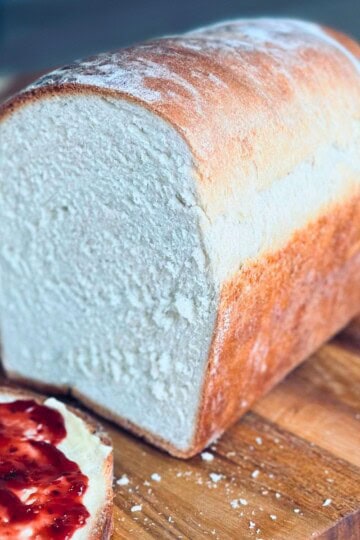 Cottage cheese bread sliced on a cutting board.