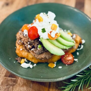 Indian taco in a green bowl.