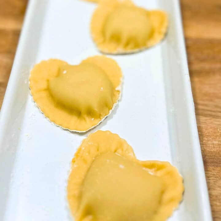Heart shape ravioli on a plate.