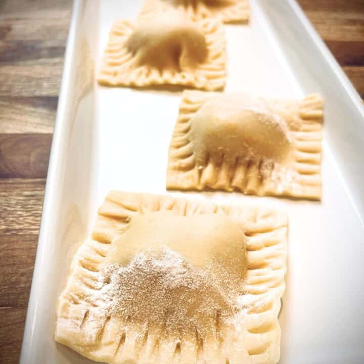 Butternut squash ravioli on a white platter.