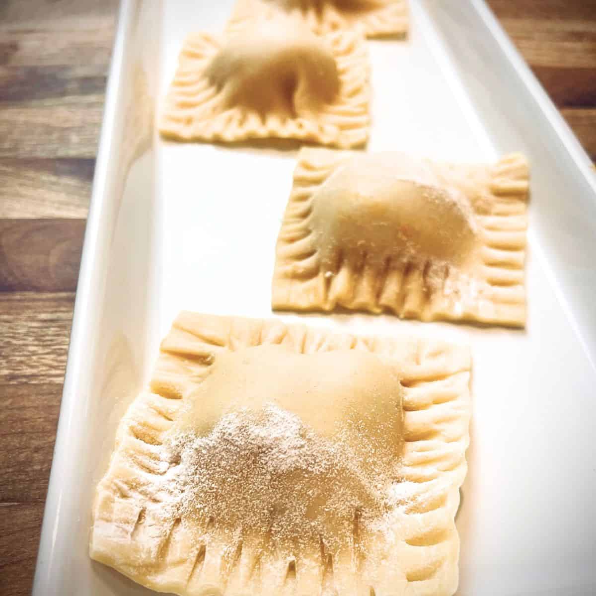 Butternut squash ravioli on a white platter.