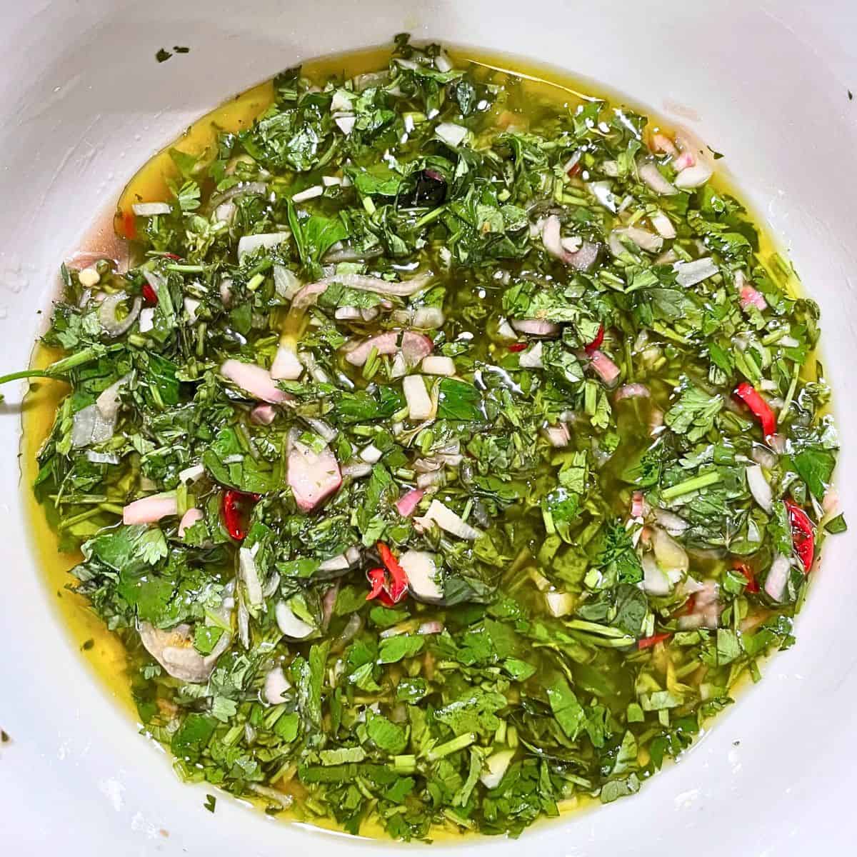 A birdseye view of Chimichurri in a white bowl.