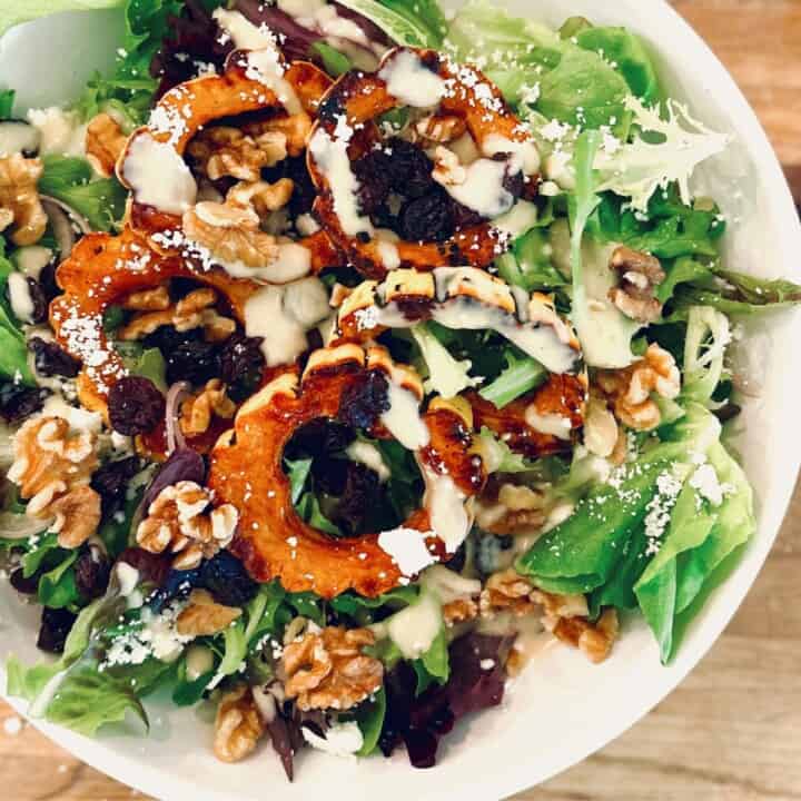 Delicata squash salad in a white bowl.
